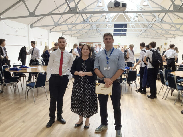 St Vincent College business teacher Iain Sutherland, right, with judges Beverley Gent and Damian Berg from Churchers Solicitors